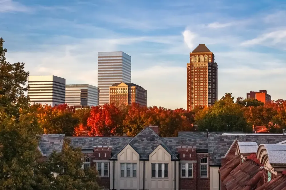 Office towers and autumn trees above slate roofs in Clayton, Missouri